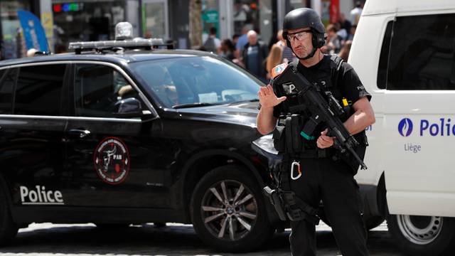 A member of the special police forcess gestures in Liege