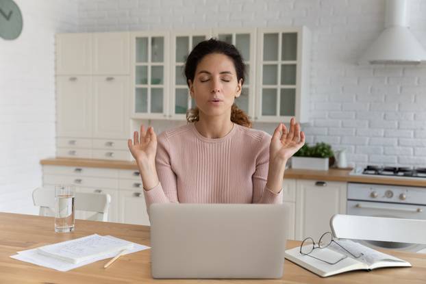 Young,Hispanic,Businesswoman,Sit,At,Table,In,Kitchen,Near,Computer