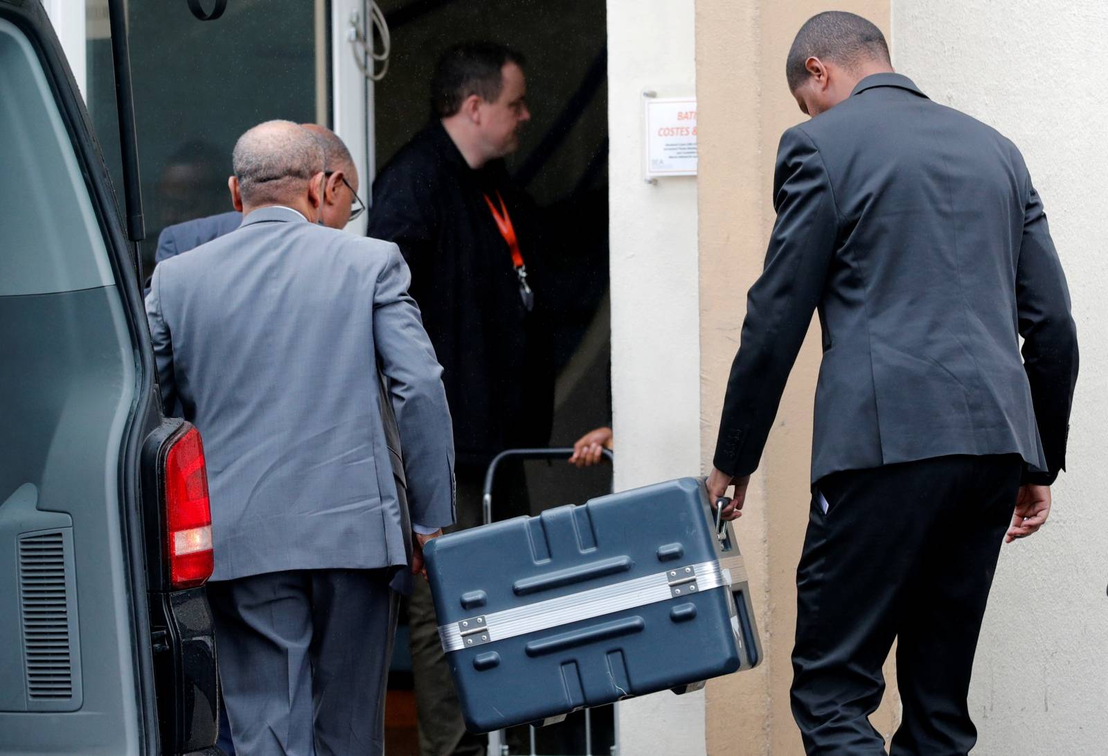 Men unload a case containing the black boxes from the crashed Ethiopian Airlines Boeing 737 MAX 8 outside the headquarters of France's BEA air accident investigation agency in Le Bourget