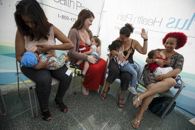 FILE PHOTO - Mothers breastfeed their children as they take part in the 2015 Global "Big Latch On" event at Queens Hospital Center in the Queens borough of New York