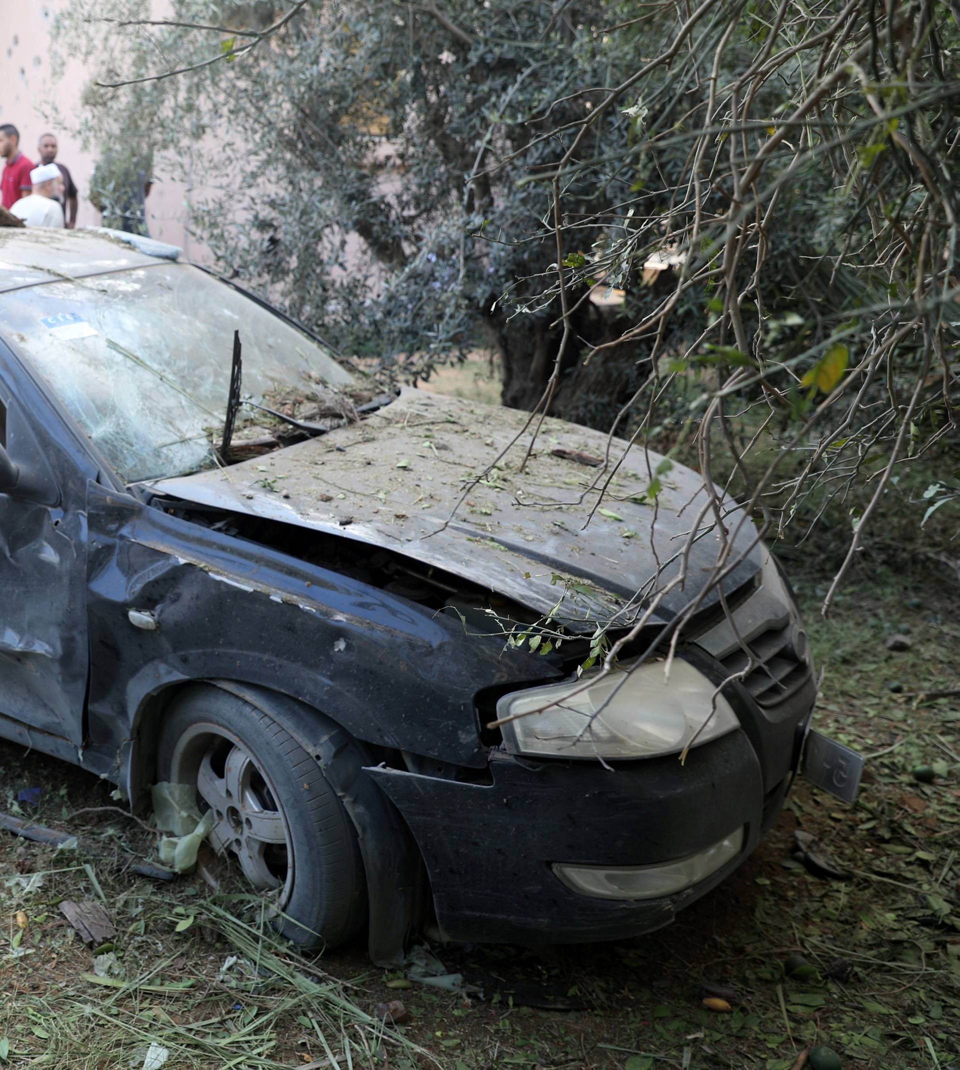 A damaged car is seen during clashes between rival factions in Tripoli, Libya