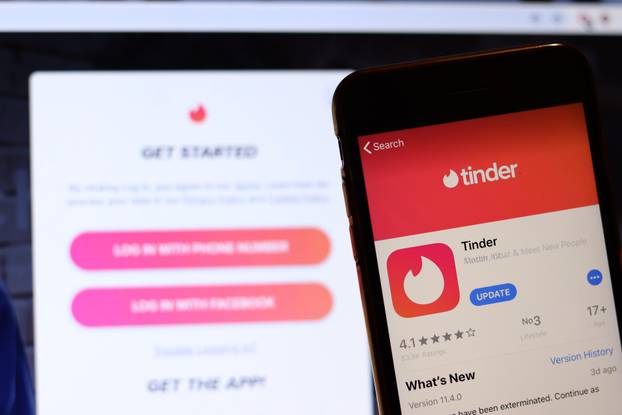 Los Angeles, California, USA - 26 November 2019: Tinder icon on phone screen with logo on blurry background, Illustrative Editorial
