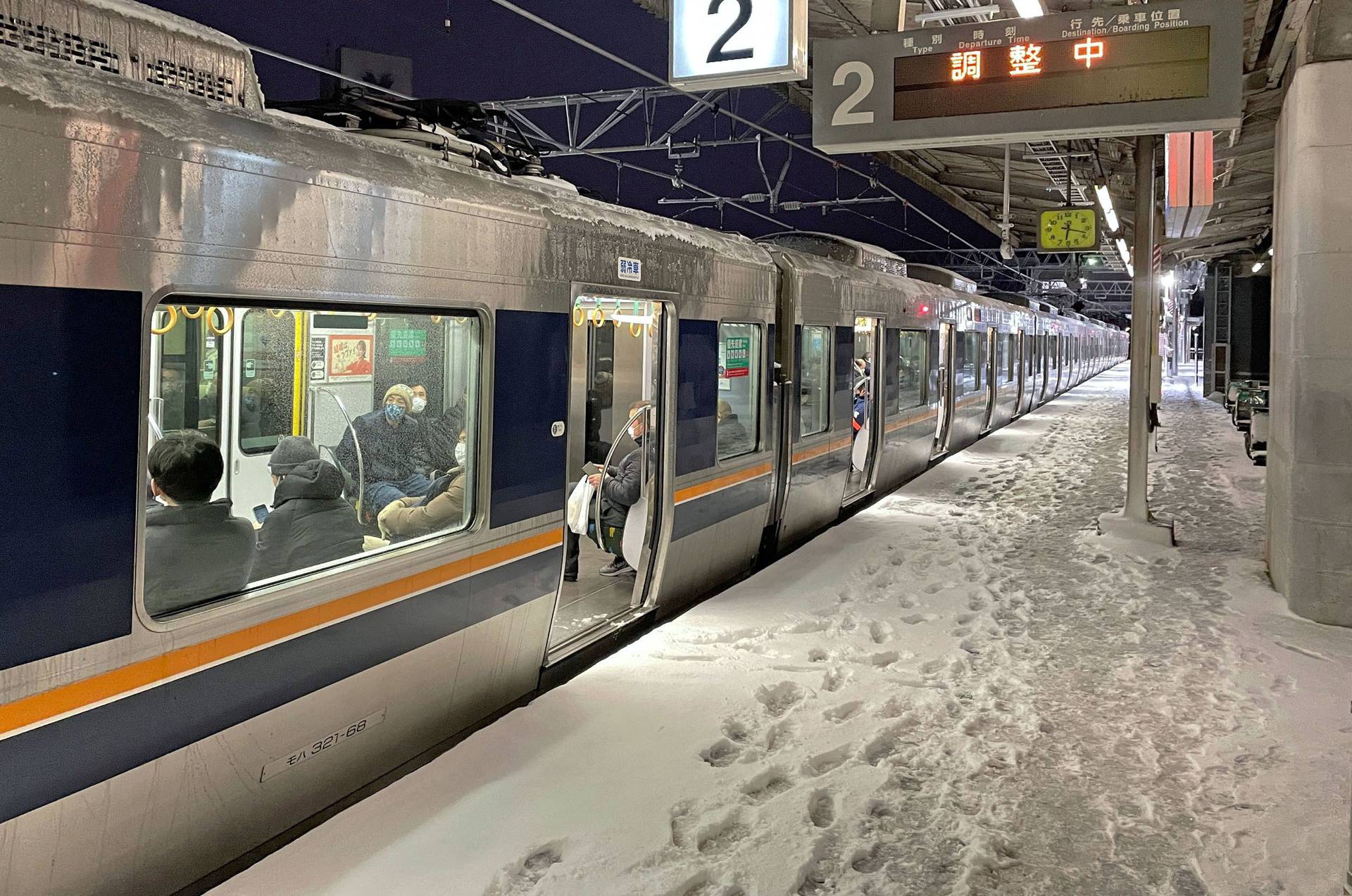 A train is stranded due to heavy snow at Nishioji station in Kyoto