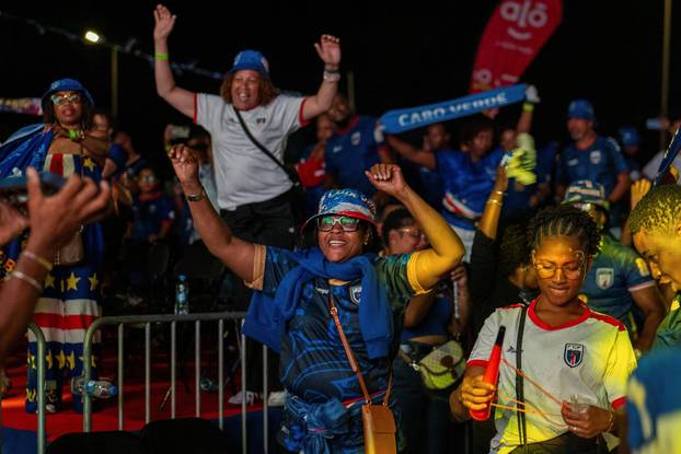 Fans of the Cape Verde national soccer team celebrate as they watch a World Cup group stage match against Uruguay in Praia