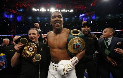 Anthony Joshua celebrates with trainer Robert McCracken after winning the fight