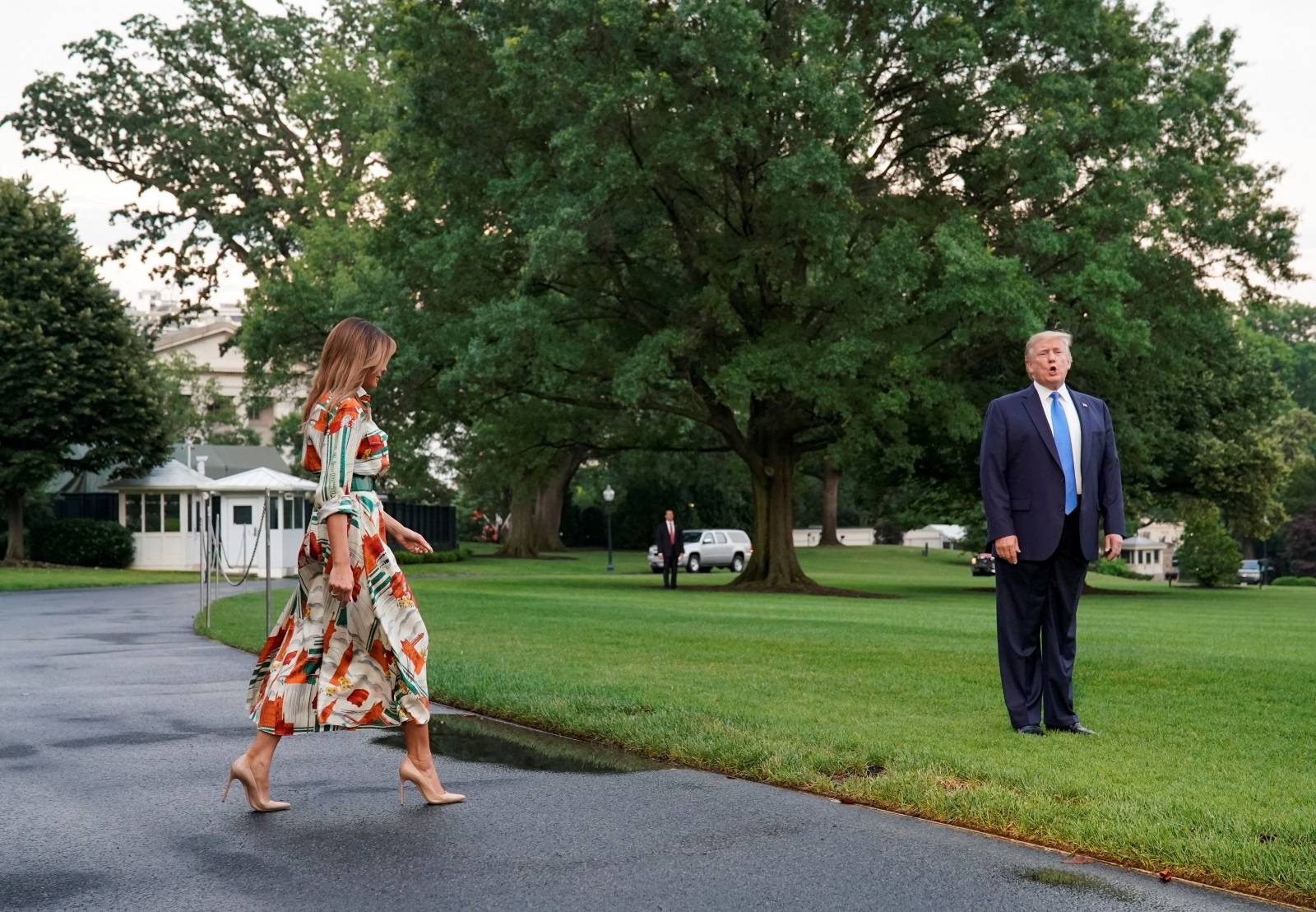 U.S. President Donald Trump and U.S. first lady Melania Trump walk to Marine One as they depart for London from the White House in Washington