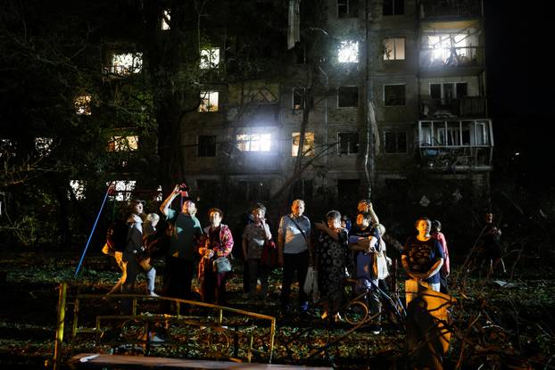 Firefighters work at the site of an apartment building hit by a Russian missile strike in Kyiv