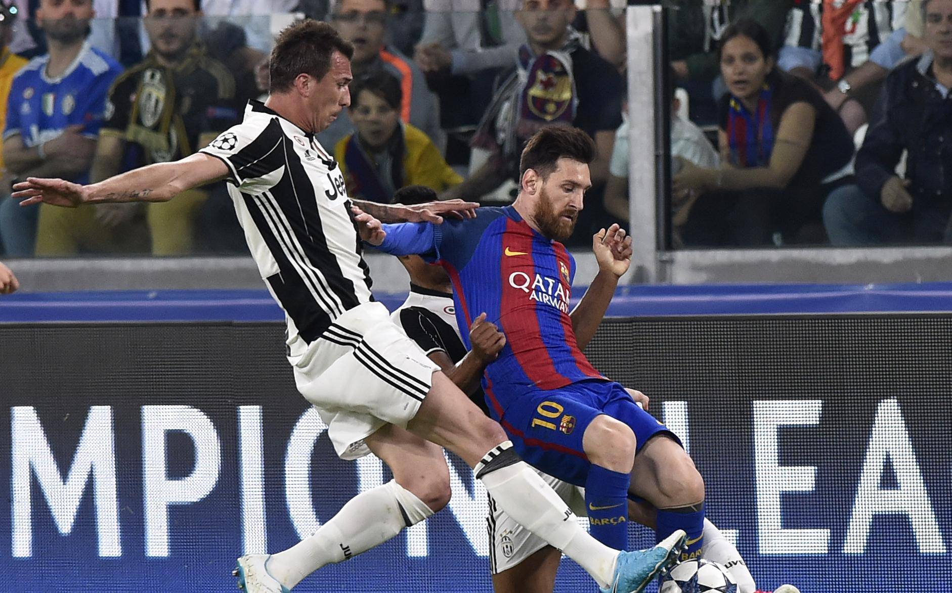 Barcelona's Lionel Messi in action with Juventus' Mario Mandzukic