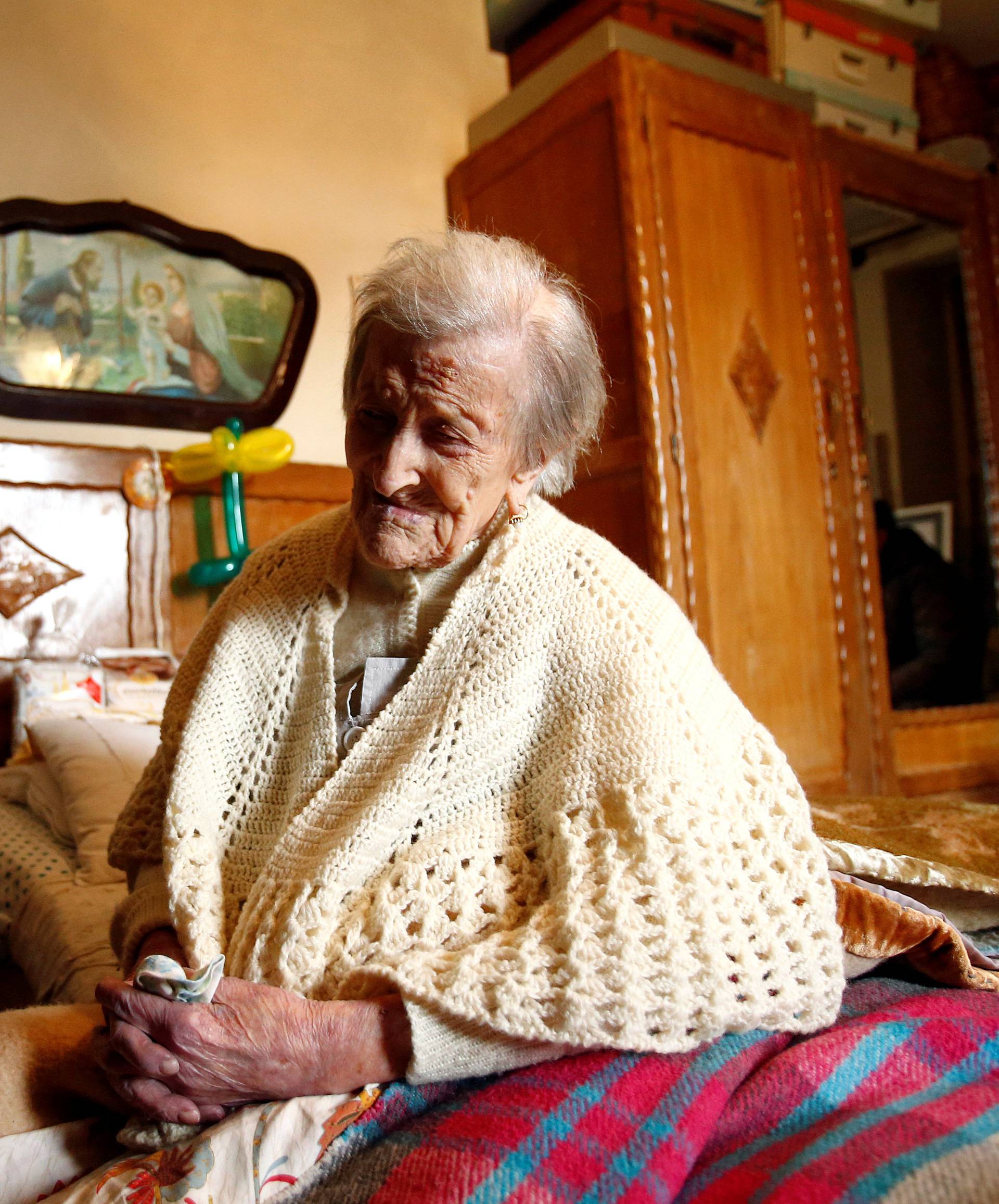 Emma Morano, thought to be the world's oldest person and the last to be born in the 1800s, sits on her bed during her 117th birthday in Verbania