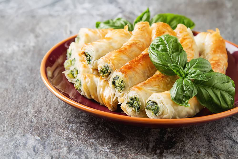 Traditional,Homemade,Greek,Cheese,,Spinach,Pie,On,A,Red,Plate.