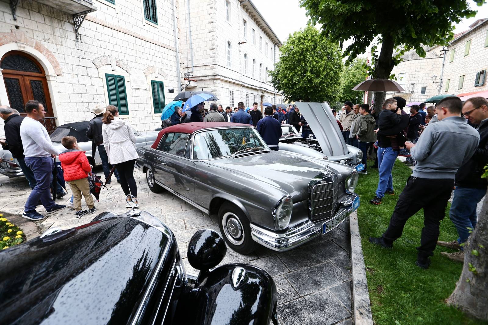 People look at oldtimer Mercedes cars in Imotski