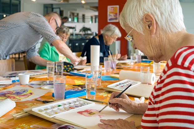 Woman,In,Striped,Red,And,White,Shirt,Working,On,Watercolor