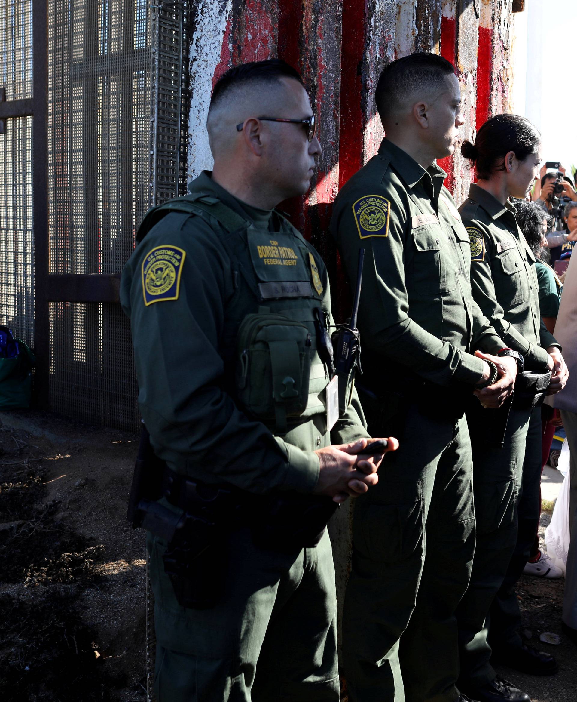 U.S. resident Brian Houston marries Evelia Reyes as U.S. Border Patrol agents open a single gate in the border wall to allow selected families to visit along the U.S.-Mexico border in San Diego