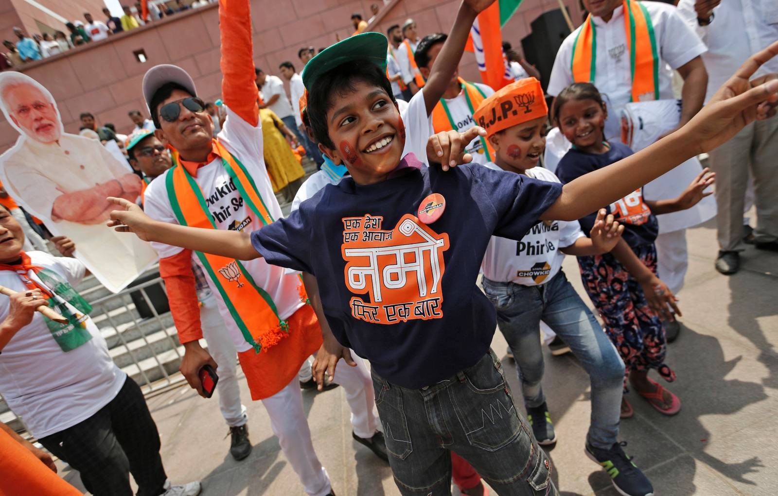 Bharatiya Janata Party (BJP) supporters celebrate after learning the election results at party headquarters in New Delhi