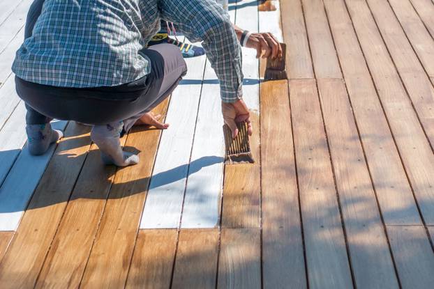 labor painting the wooden floor 