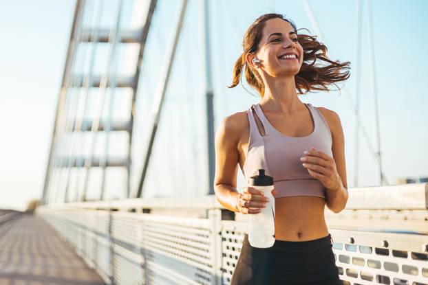 Energetic,Woman,Jogging,On,A,Bridge,,Embodying,Health,,Vitality,,And