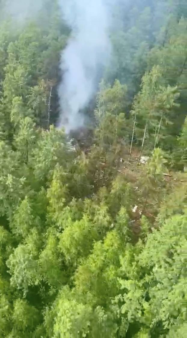 Smoke rises at the site of a plane crash in the Amur Region