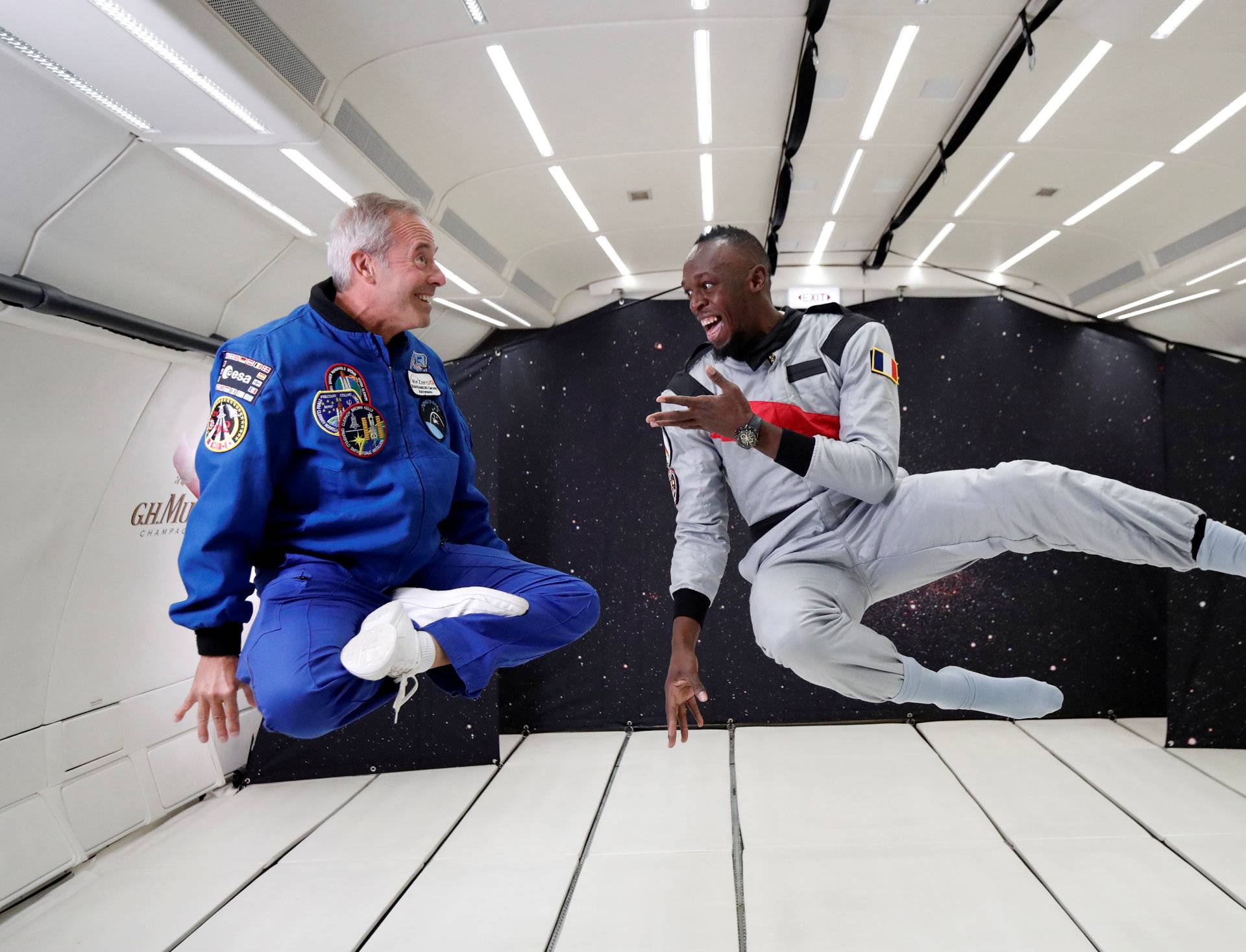 Retired sprinter Usain Bolt and French astronaut Jean-Francois Clervoy enjoy zero gravity conditions during a flight in a specially modified plane above Reims