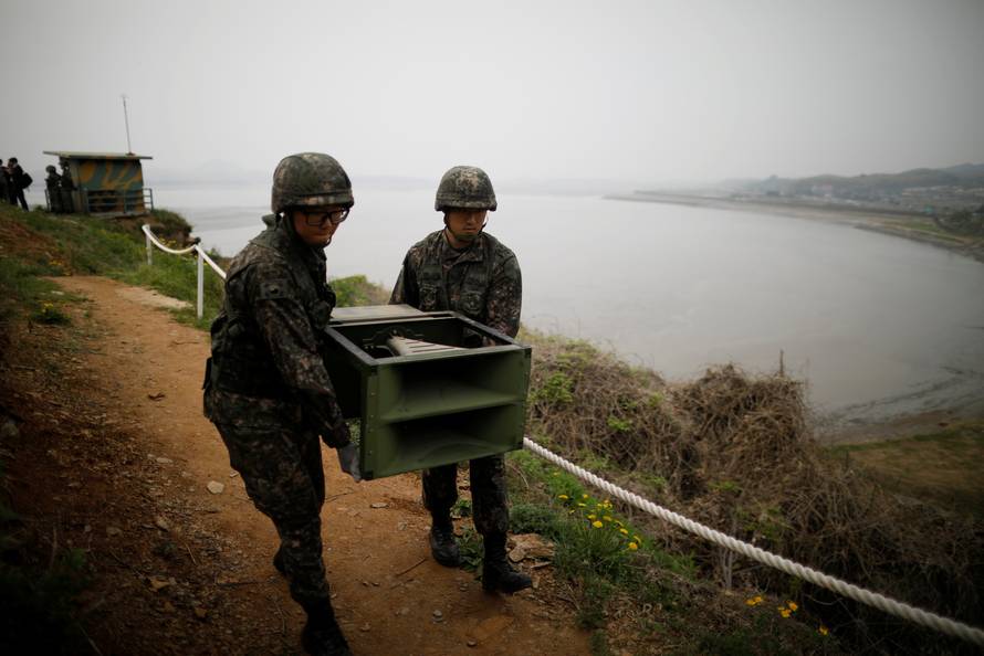 South Korean soldiers move loudspeakers that were set up for propaganda broadcasts near the demilitarized zone separating the two Koreas in Paju