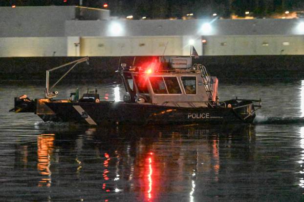 Police boat patrols aircraft helicopter crash scene in Washington DC