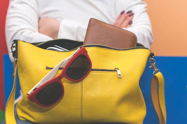 Girl holding her bag. Search for items in the bag.