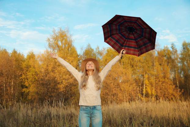Happy,Woman,In,Autumn,Park,With,Umbrella,Raising,Her,Hands