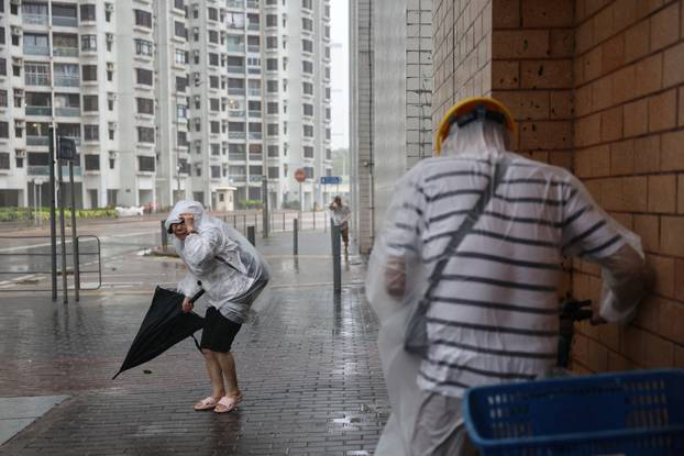 People brave strong winds as Super Typhoon Ragasa approaches, in Hong Kong