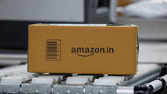 FILE PHOTO: A shipment moves on a conveyor belt at an Amazon Fulfillment Centre