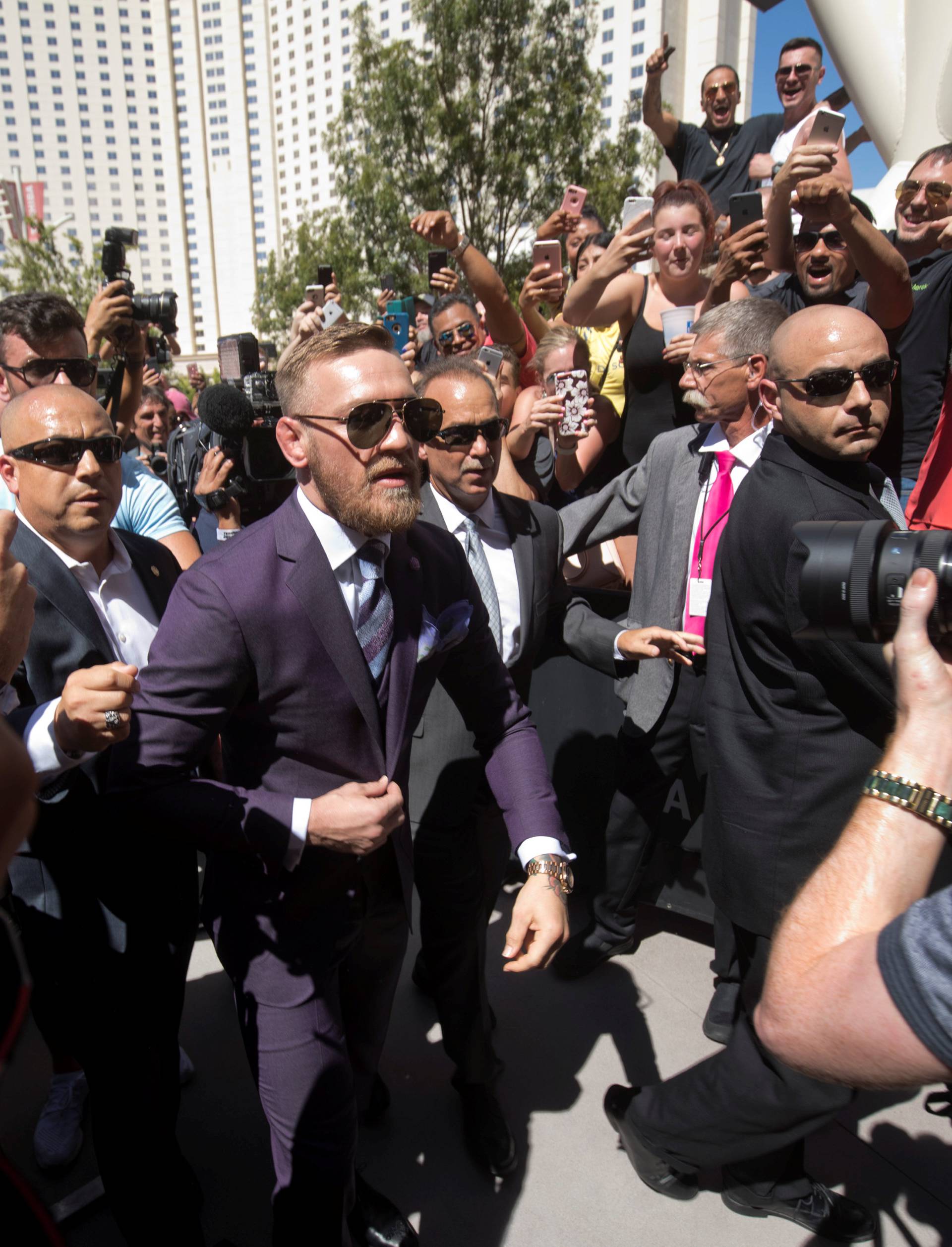 UFC lightweight champion Conor McGregor of Ireland greets fans as he arrives at Toshiba Plaza in Las Vegas