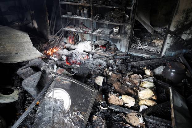 Burnt and damaged items lie at property after a wildfire devastated the area, in Uiseong
