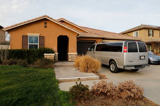 A van sits parked on the driveway of the home of the Turpins in Perris