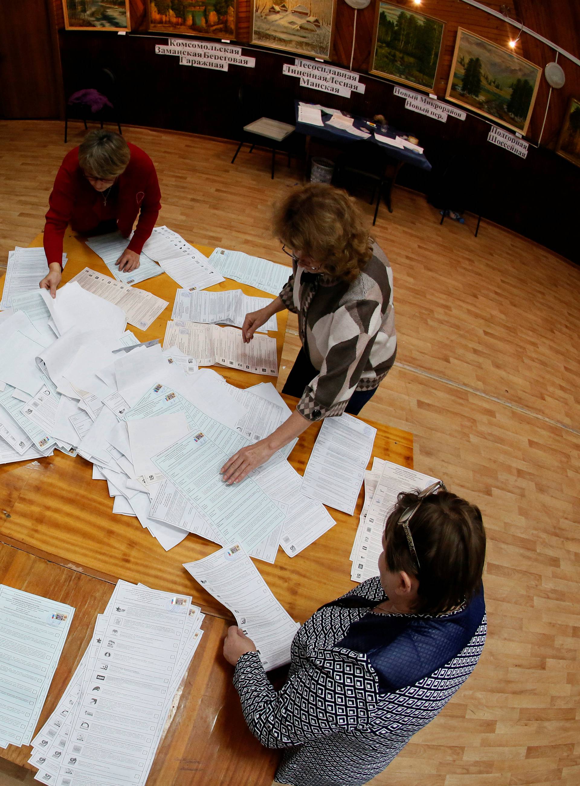 Members of local election commission count votes during parliamentary election in Ust-Mana outside Krasnoyarsk