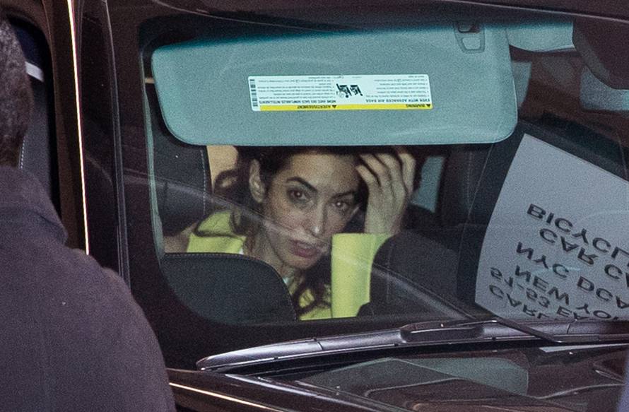George CLooney and Amal Clooney put their kids into the SUV in the garage at a hotel in New York