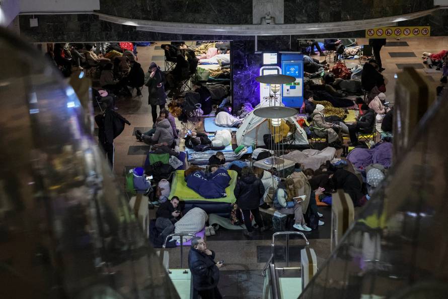 People take shelter inside a metro station during a Russian missile and drone attack in Kyiv