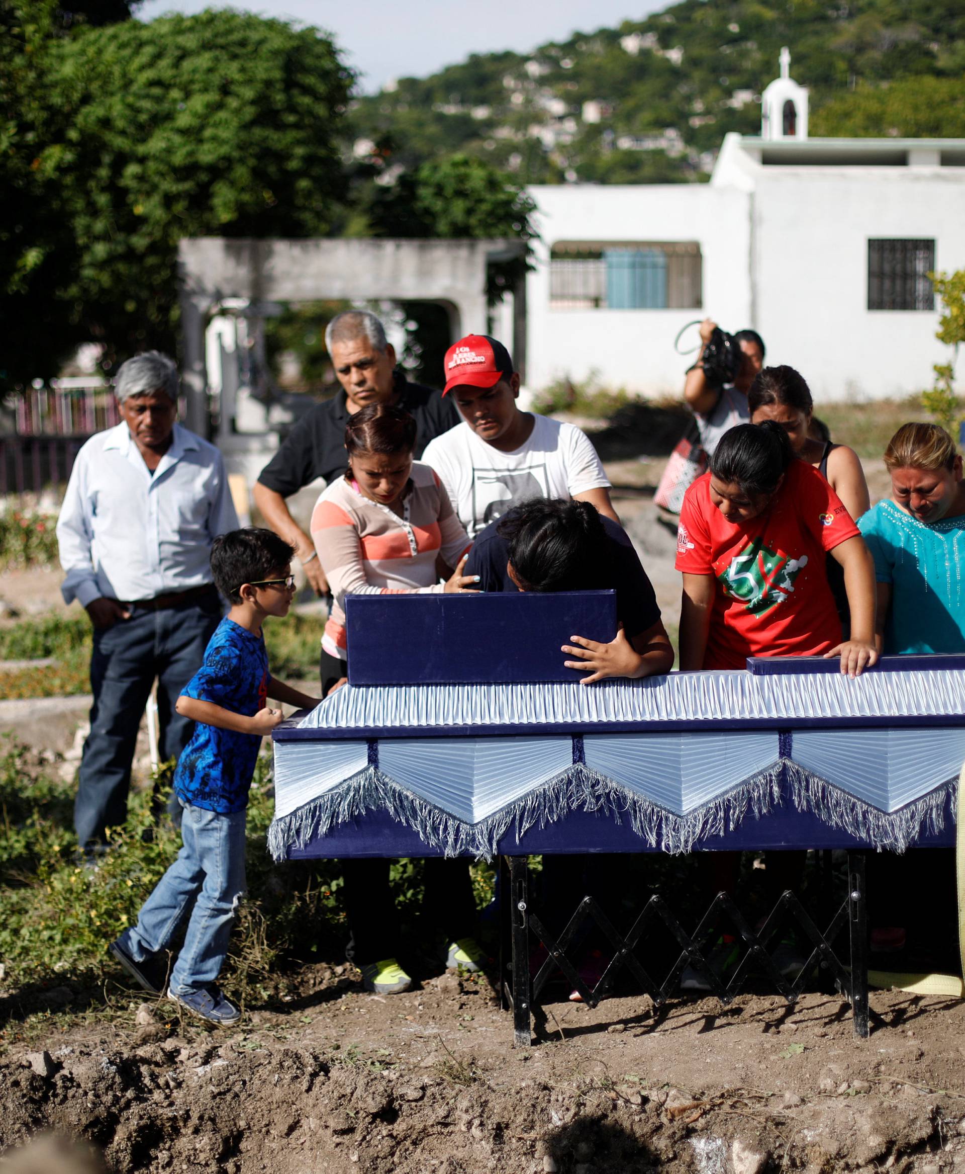 Family members and friends attend the funeral of a woman who was killed in an earthquake, in Jojutla de Juarez