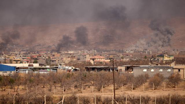 Smoke rises during clashes between Peshmerga forces and Islamic State militants in the town of Bashiqa, east of Mosul
