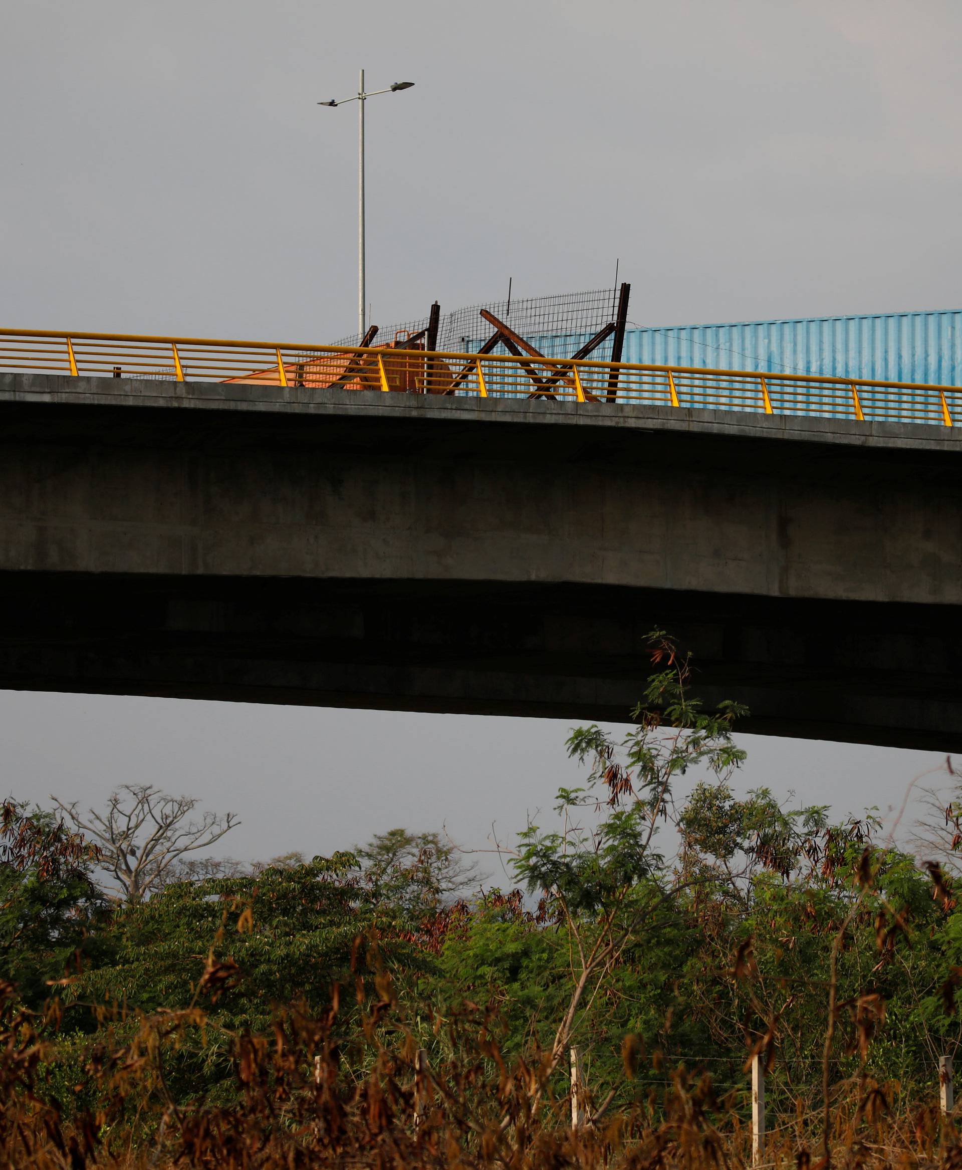 A fuel tank and a container are seen blocking the vehicular passage on the Venezuelan side of the Tienditas cross-border bridge between Colombia and Venezuela, as seen from Cucuta