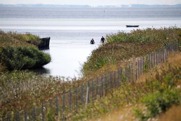 Members of the Danish Emergency Management Agency (DEMA) (Danish: Beredskabsstyrelsen) assist police at Kalvebod Faelled in search of missing body parts of journalist Kim Wall close to the site where her torso was found, in Copenhagen