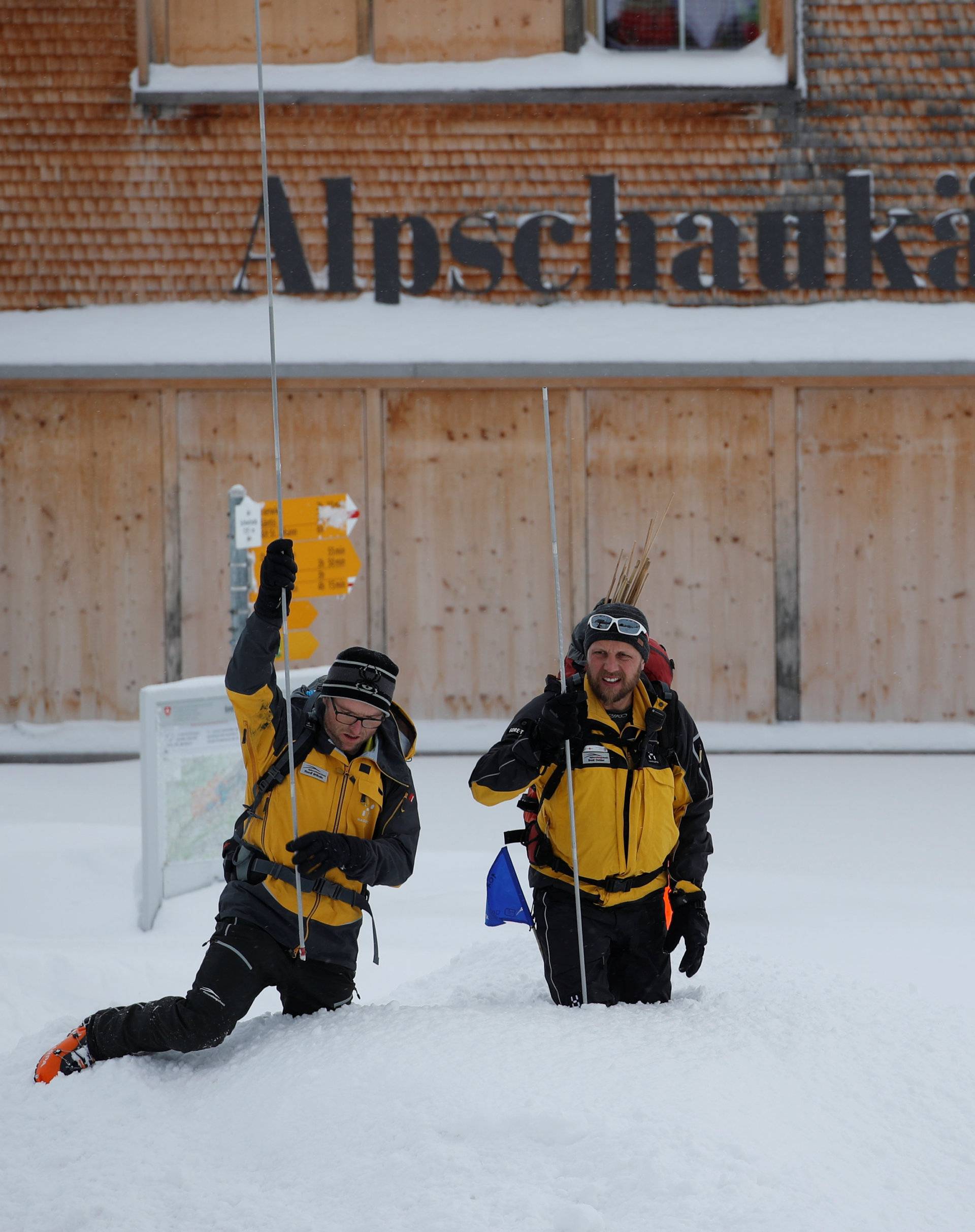 Rescue workers use probes to search after avalanche at Santis-Schwaegalp