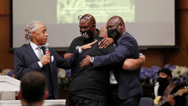 Terrence, brother of George Floyd, is comforted by Rev. Al Sharpton, his brother Philonise, and attorney Ben Crump during a prayer vigil in Minneapolis