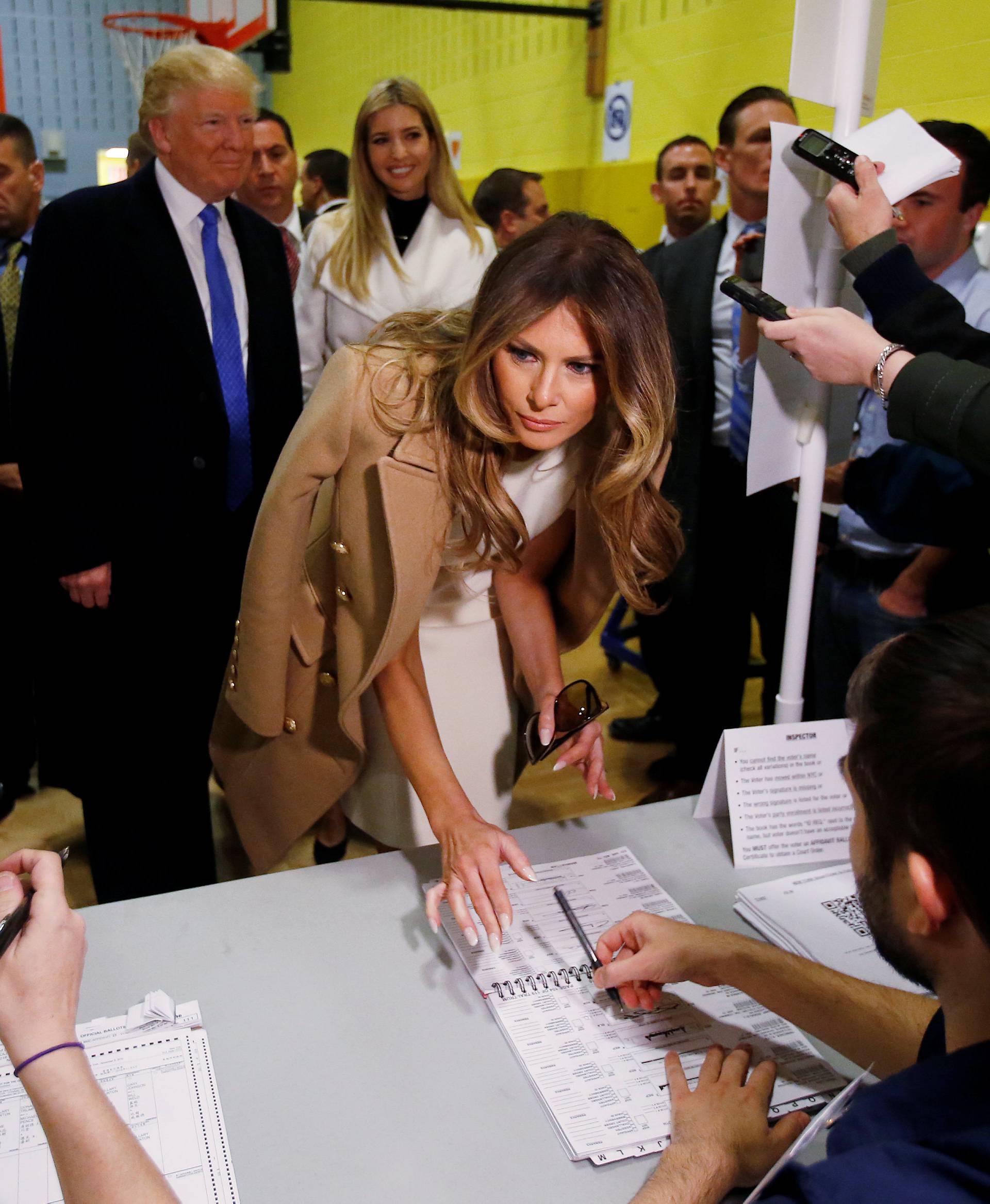 Republican presidential nominee Donald Trump's wife Melania signs her name before she votes at PS 59 in New York