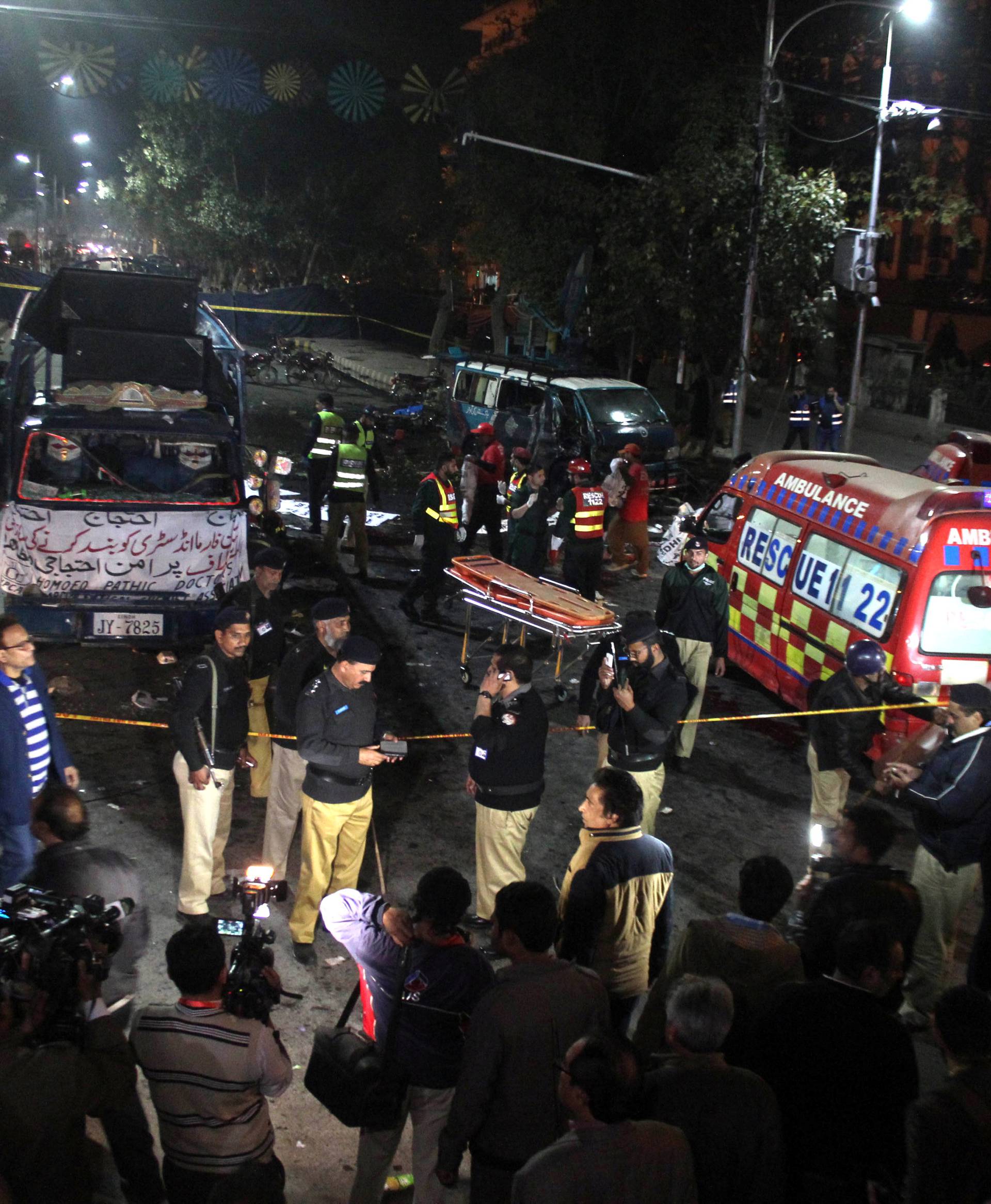 Police and rescue workers work at the scene of a blast in Lahore