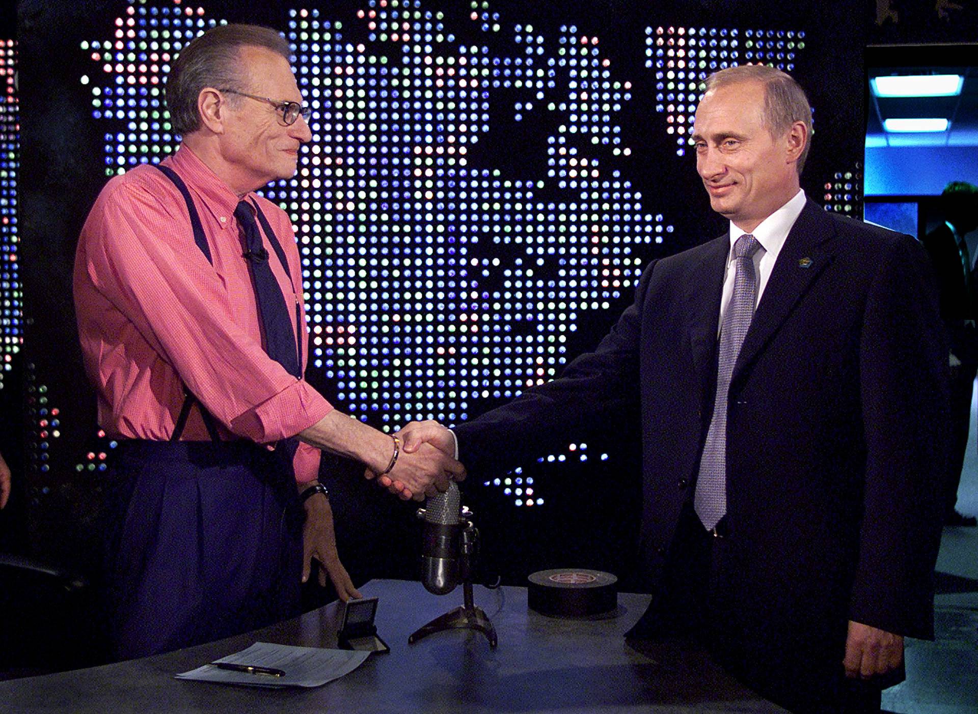 FILE PHOTO: Putin shakes hands with Larry King before taping of "The Larry King Show" in New York