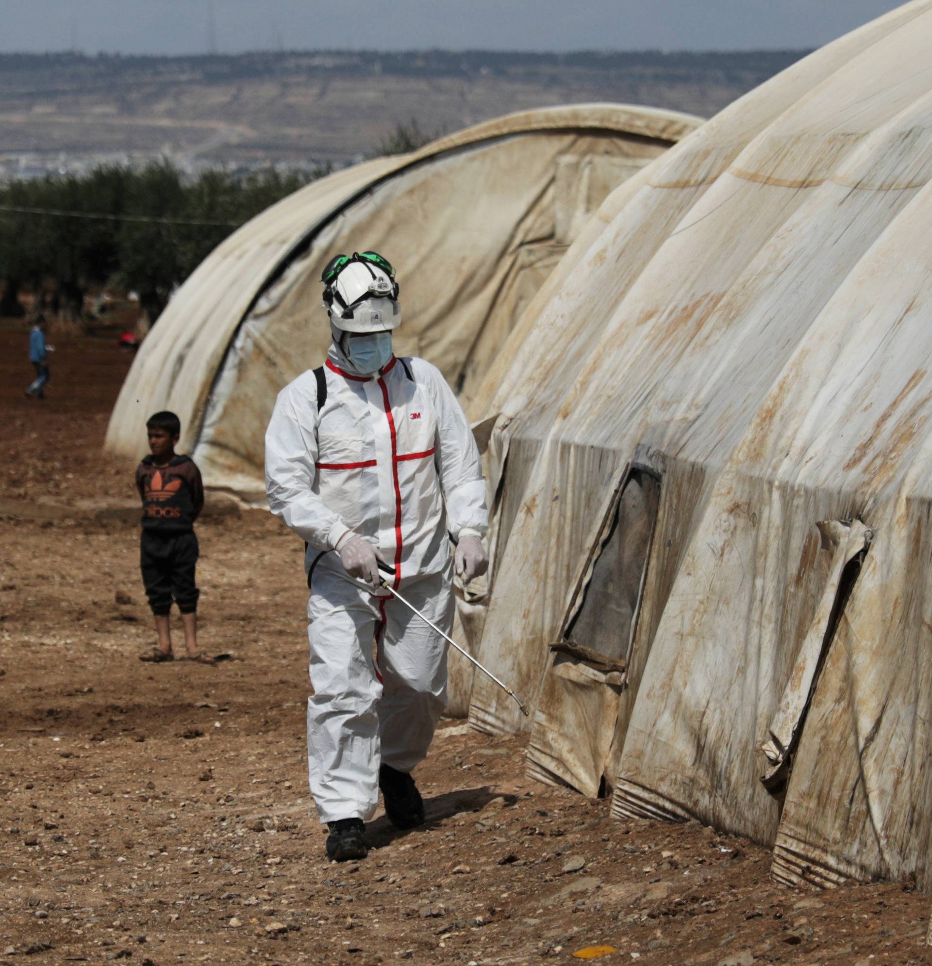 FILE PHOTO: A member of the Syrian Civil defence sanitizes a tent at the Bab Al-Nour internally displaced persons camp, to prevent the spread of coronavirus disease (COVID-19) in Azaz