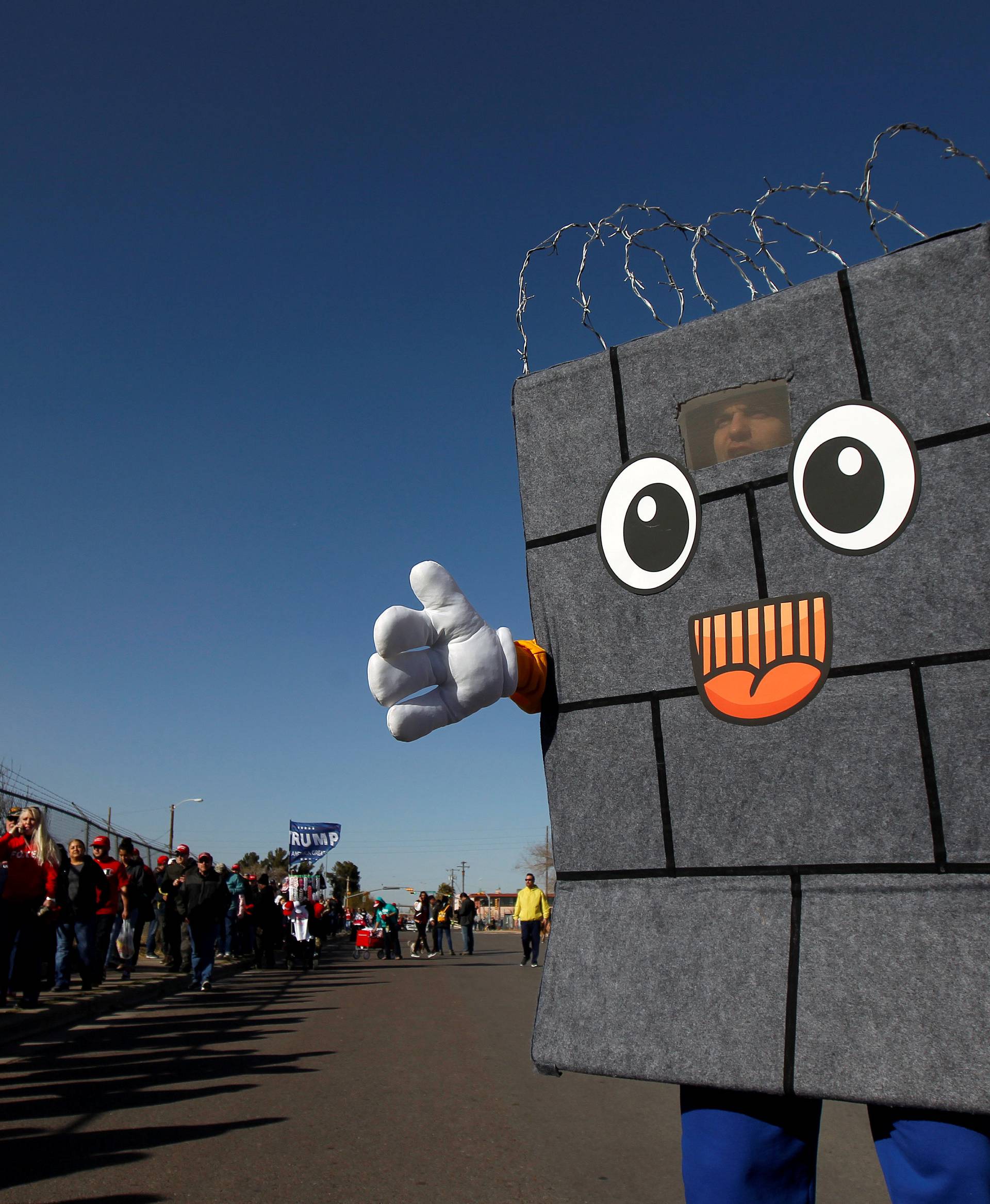A Trump supporter dressed up as a border wall is seen as others queue to enter El Paso County Coliseum for a rally by U.S. President Trump in El Paso