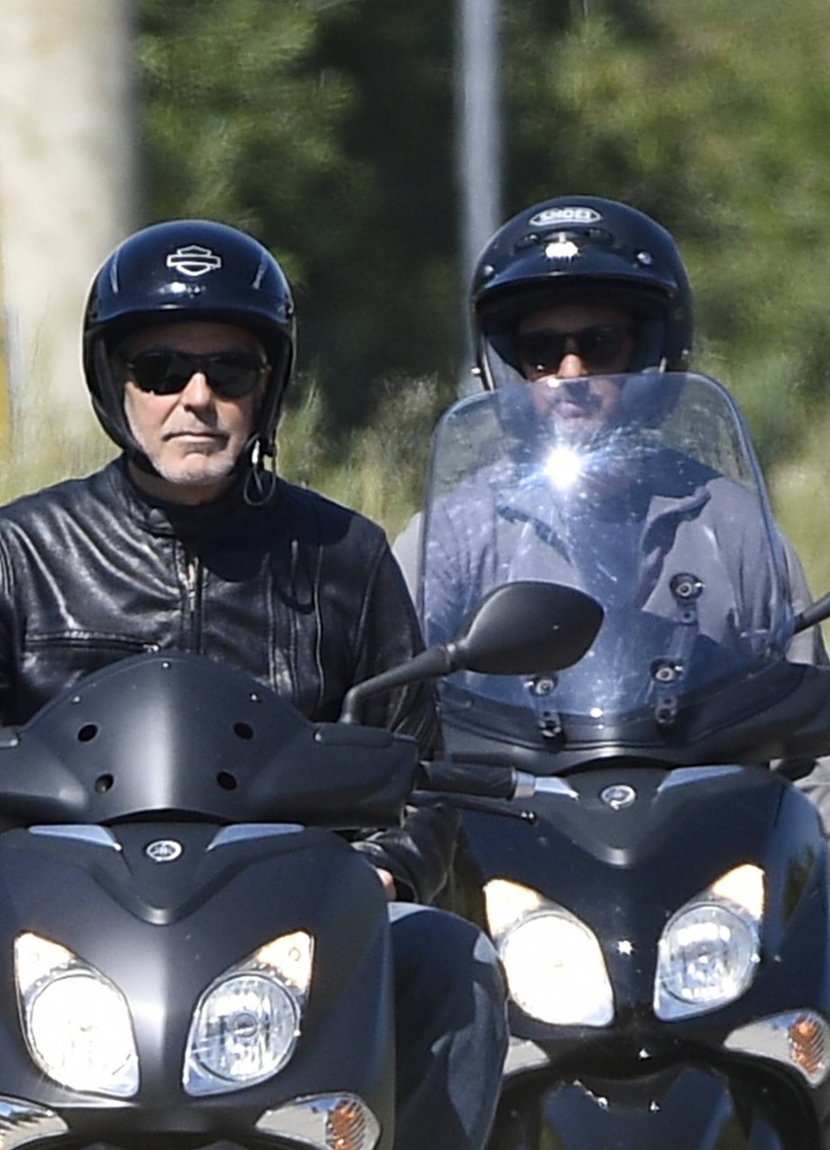 George Clooney riding a scooter in Sardinia