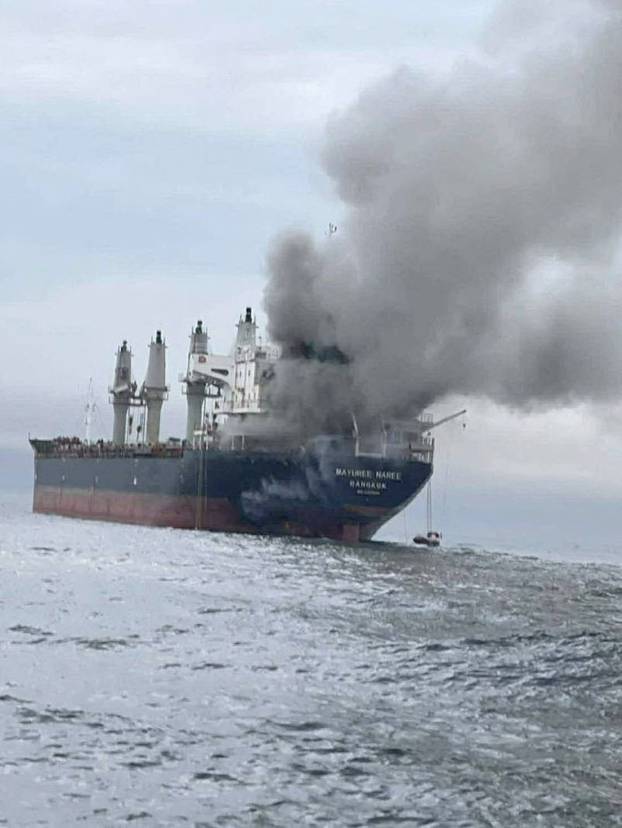 The Thailand-flagged cargo ship Mayuree Naree engulfed in black smoke in the Strait of Hormuz