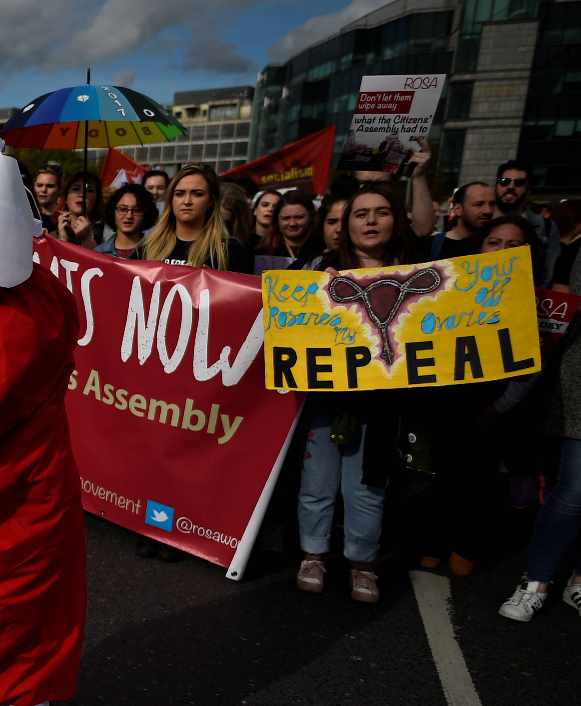 Demonstrators hold posters as they march for more liberal Irish abortion laws, in Dublin