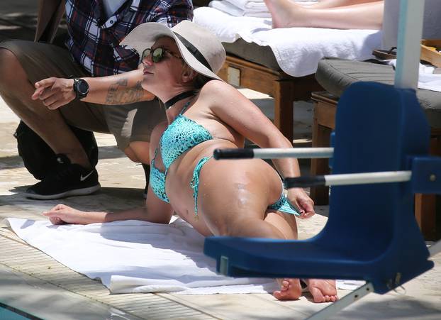 EXCLUSIVE: Britney Spears wears a very cheeky blue bikini as she sunbathes in Miami