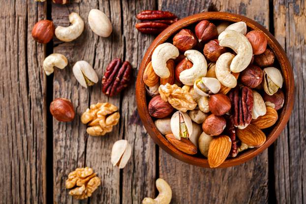 Nuts,Mixed,In,A,Wooden,Plate.assortment,,Walnuts,pecan,almonds,hazelnuts,cashews,pistachios.concept,Of,Healthy,Eating.vegetarian.selective